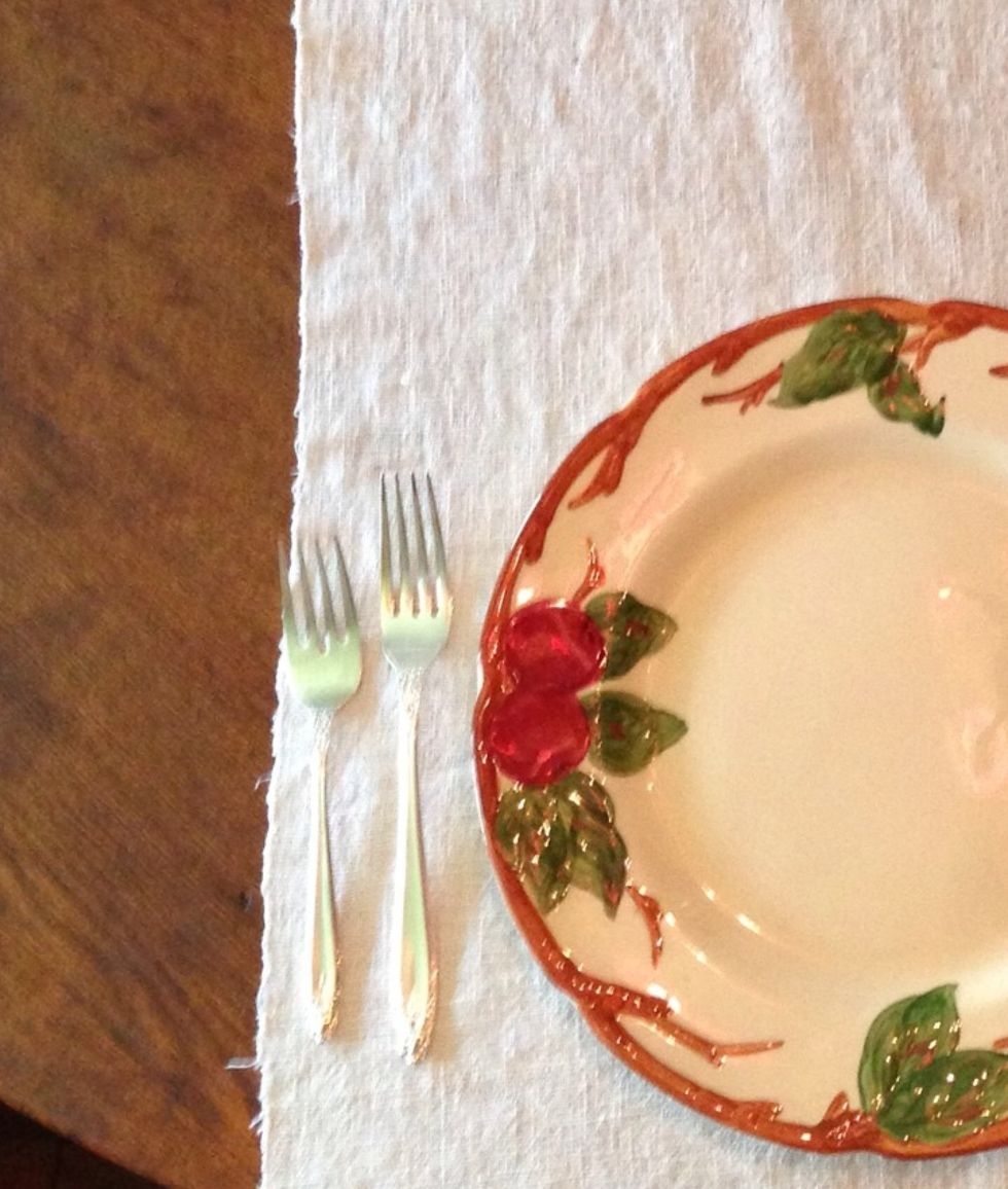 The salad fork goes to the right of the entr\u00e9e fork. The silver is always placed 'from the outside in' meaning the fork you use first is on the outer edge.