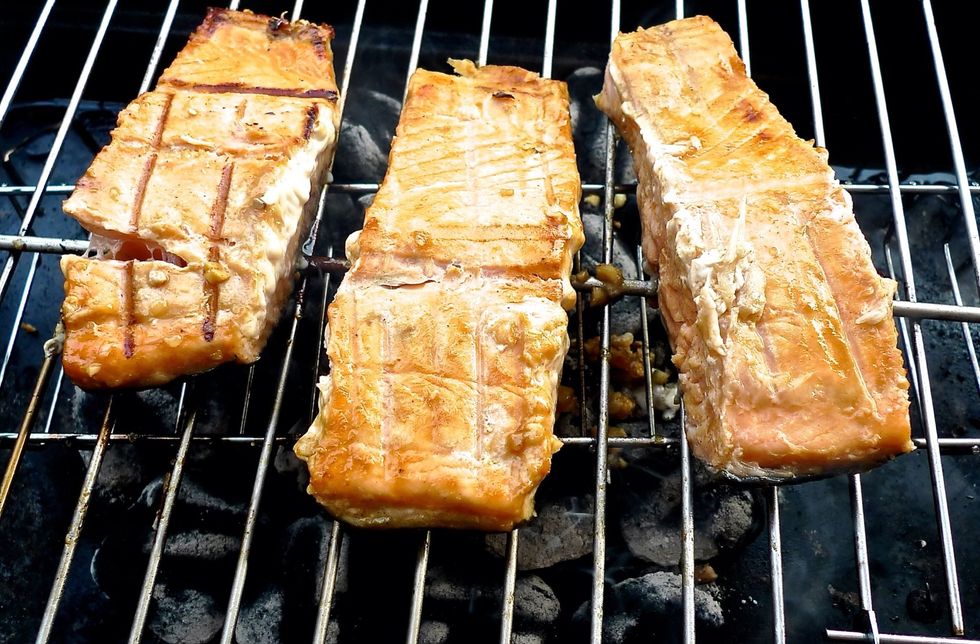 The salmon fillets are flipped, SKIN-SIDE DOWN now.