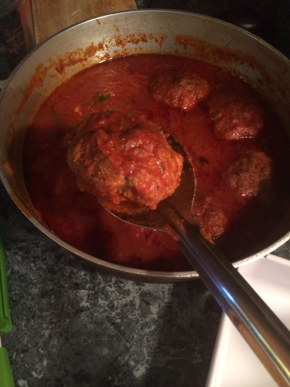 The sauce has cooled a bit. I will remove the meatballs onto a shallow pan to let it cool down before slicing.