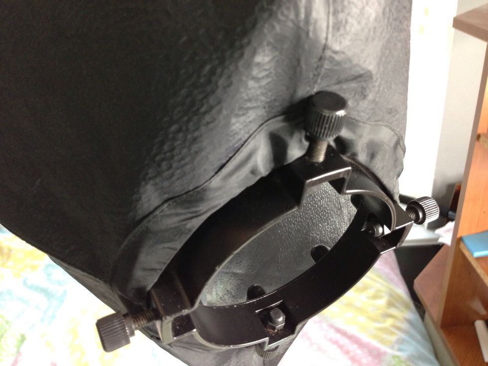 The screws should be on the outside of the soft box