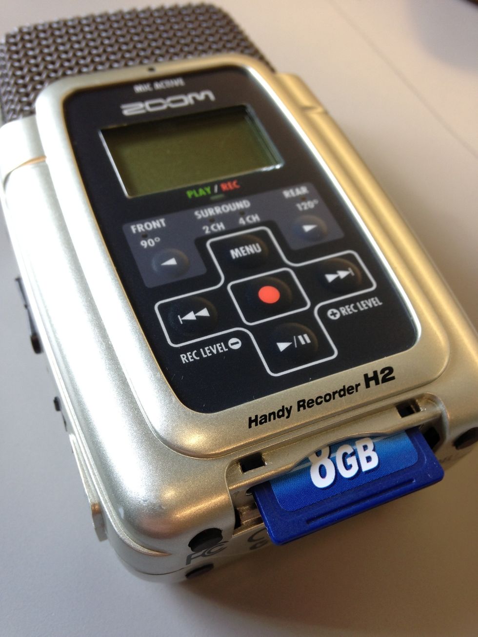 The SD card slides into the reader at the bottom of the recorder. You should hear a click when it is pushed in place.