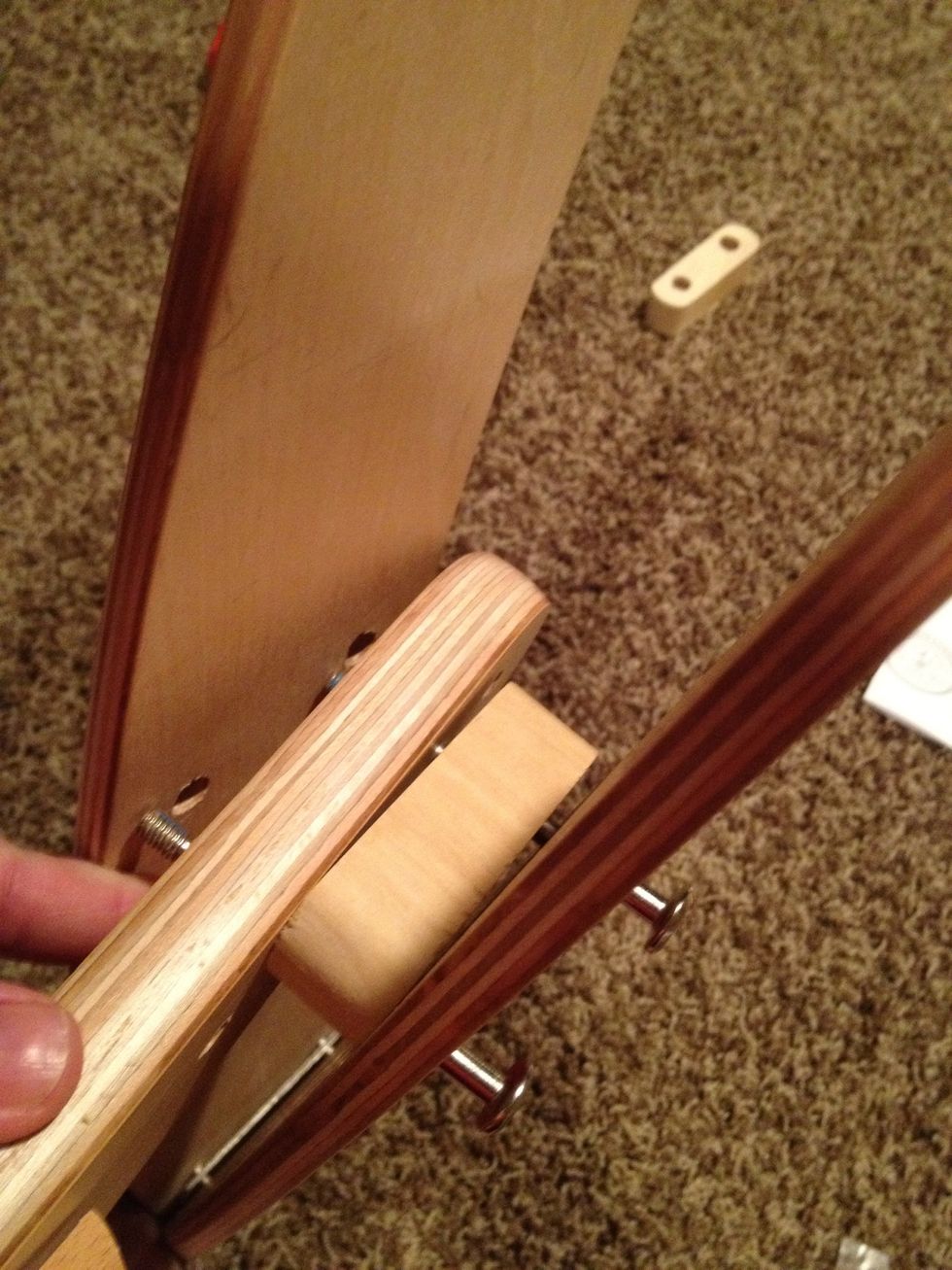 The seat goes in the center of the frame with two wooden spacers. This is the hardest part of the construction as it requires a lot of shifting and wiggling.