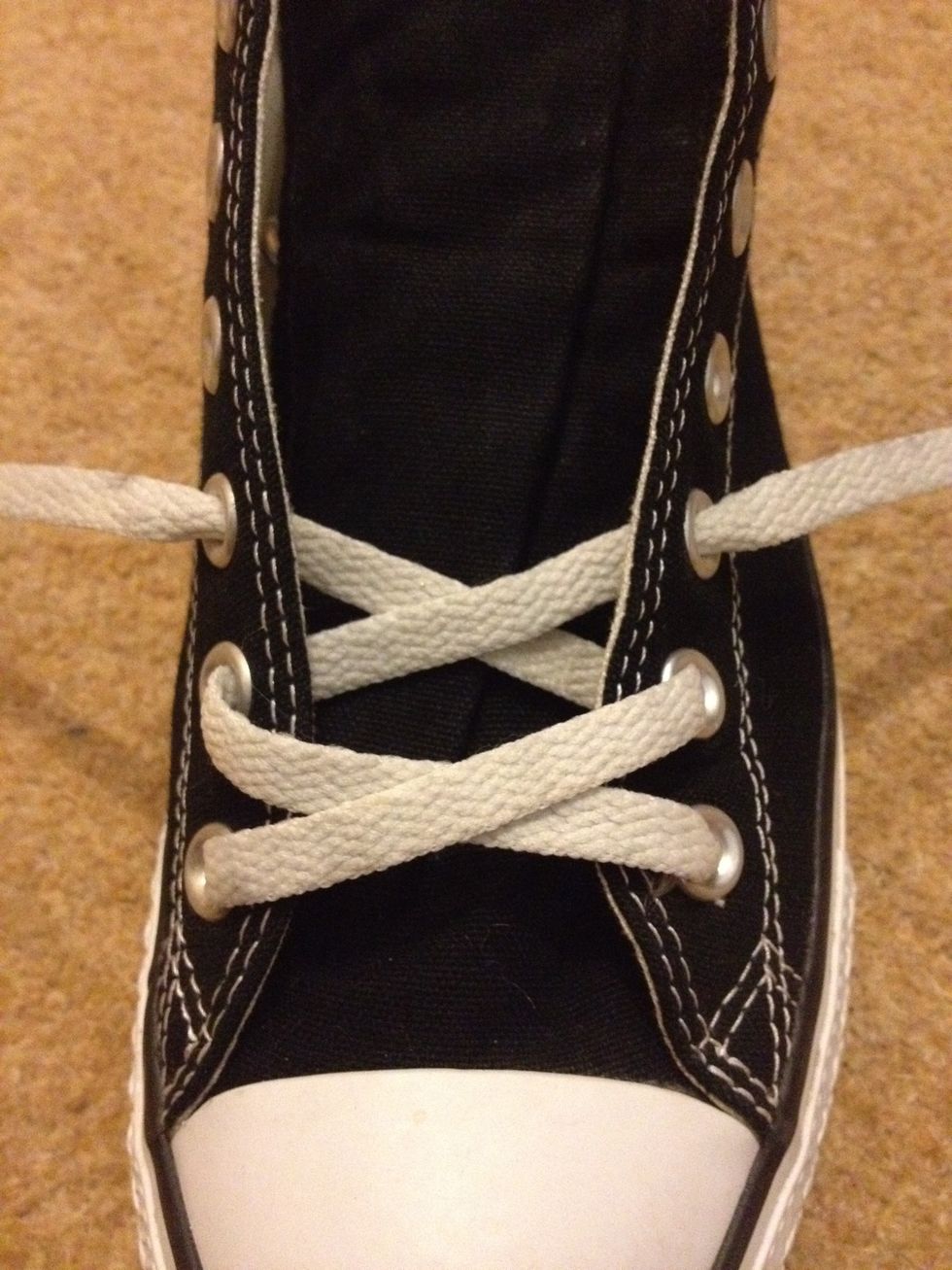 The second kiss - Cross the laces and tread them under the sneaker, and out through the third eyelets.