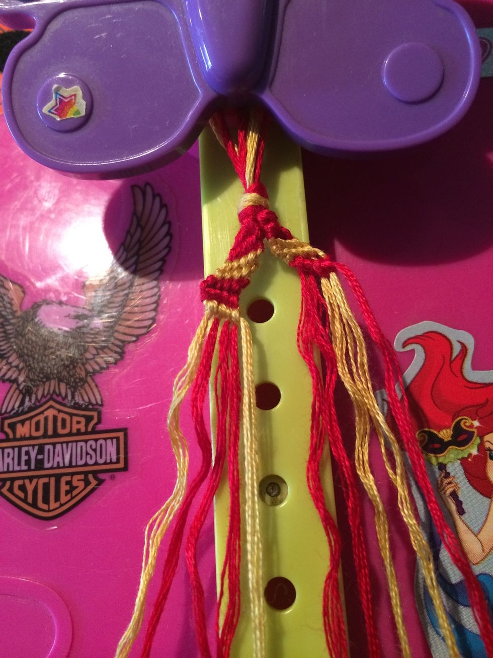 The second row is done. And let's do it again. Grab the next gold string and make your way across the other strings.