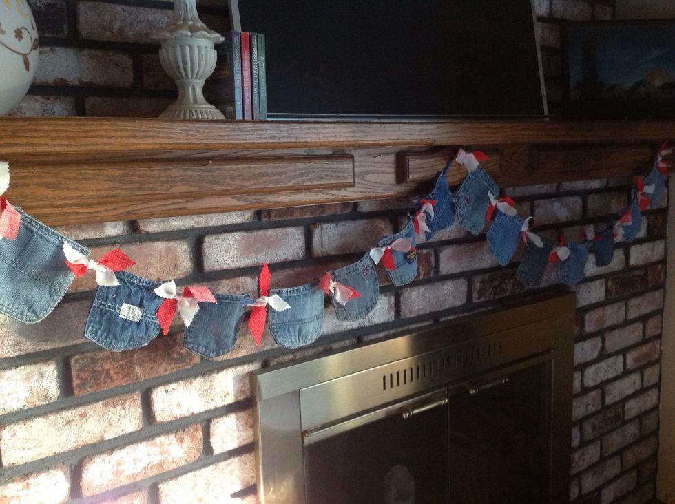 The second way I re-used the pockets was to make two swag garlands. I punched holes in the two corners of each pocket and then strung the pockets on some ribbon. (would also look great with twine)