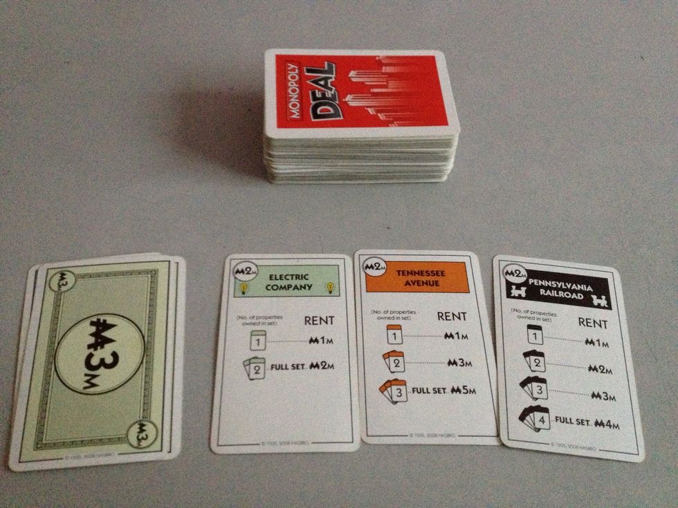 The setup will have a central draw pile, and each player will have a money pile and a property pile.