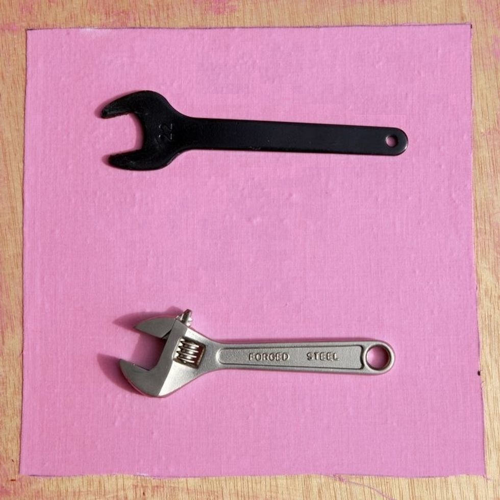 The shadow of the black wrench is less dramatic than that of the silver wrench. There are also no rounded edges on the black wrench- it lays flat up against the coated material.