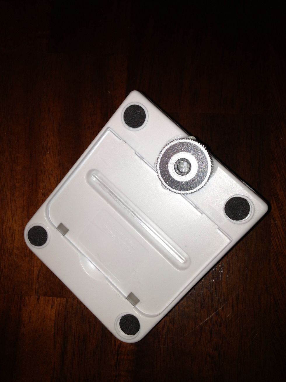 The silver piece comes on the tripod. Unthread it from the tripod and glue it to the bottom of the base. I centered it under the front right below the area that the phone rests for stability.