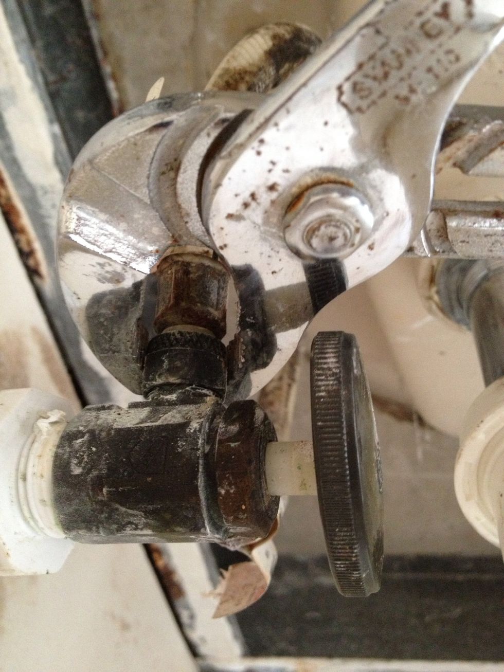The sink faucet hose has a built in collar that screws in directly to the treads of the metal valve housing.