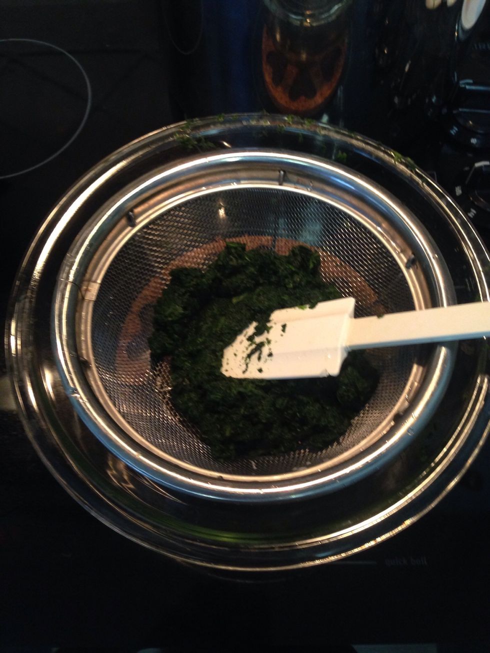 The spinach is done cooking in microwave, drain off excess water in a fine colander.