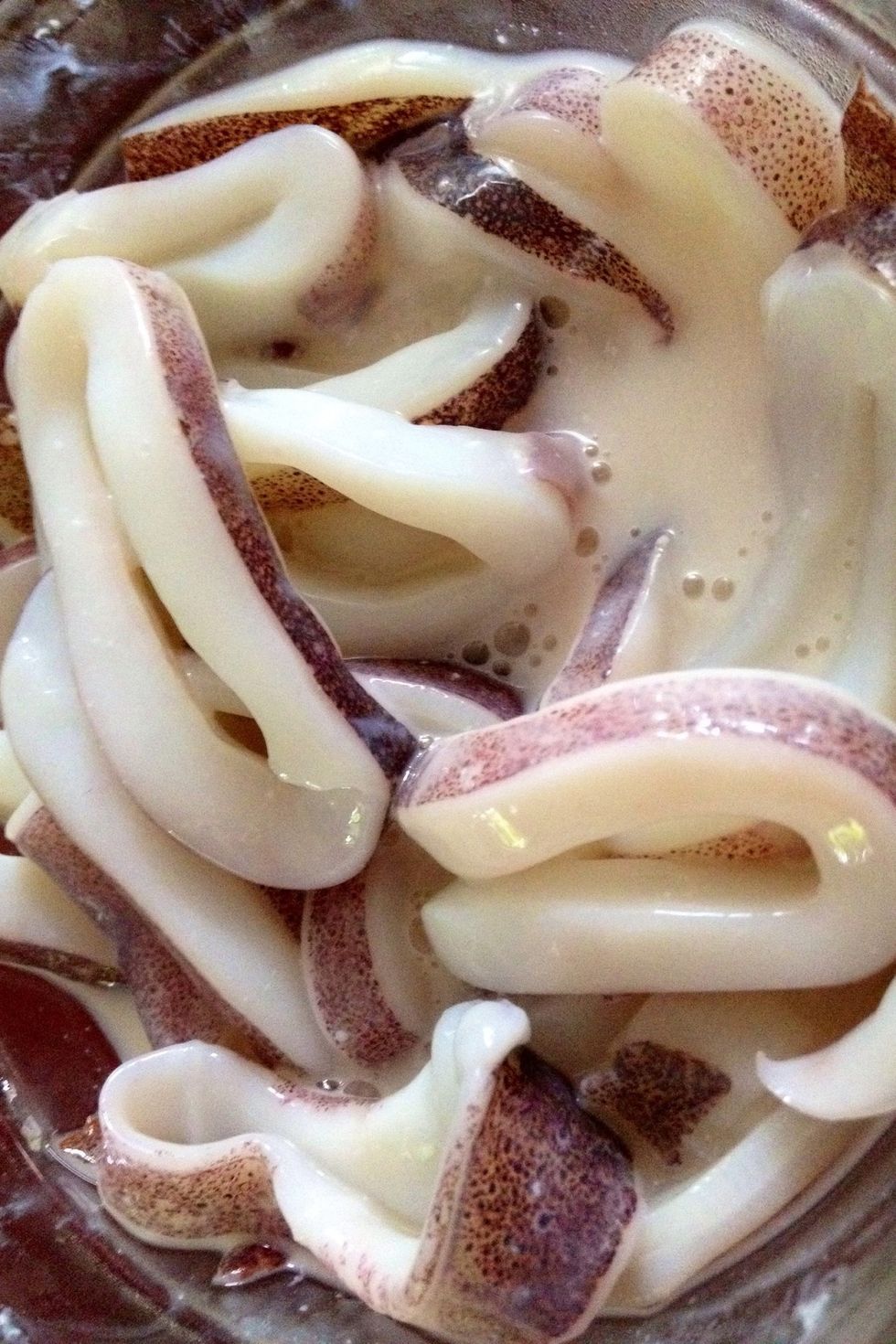 The squid can be prepared earlier. Cut squid bodies into 1/2\u2033 rings and put in a colander set over a bowl; add whole tentacles. Or marinade in buttermilk.