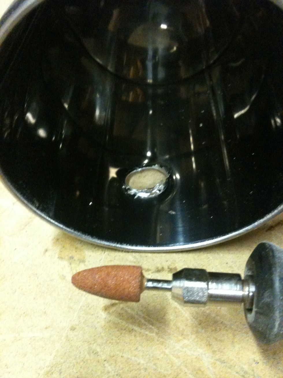 The step up bits tend to leave some frayed metal on the inside, you can use a file, pliers, or a deburring bit. Grind them down untill smooth.