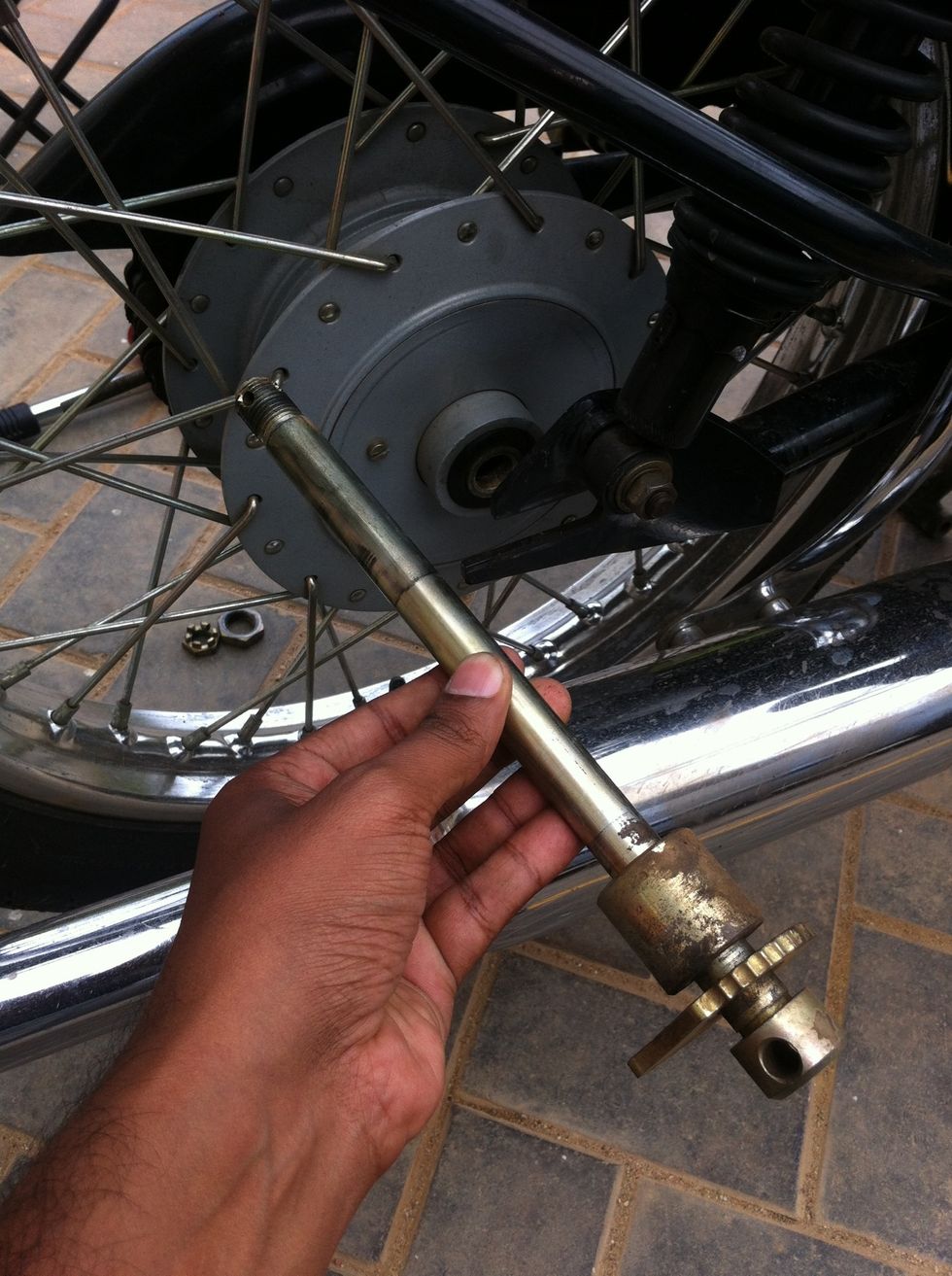 The stud along with the spacer and wheel alignment adjuster.