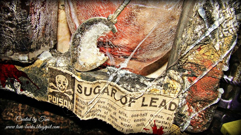 The "Sugar Of Lead" label is also from Tim Holtz Paper Stash Halloween collection. Distress the edges and apply Distress Ink in Black Soot for depth.
