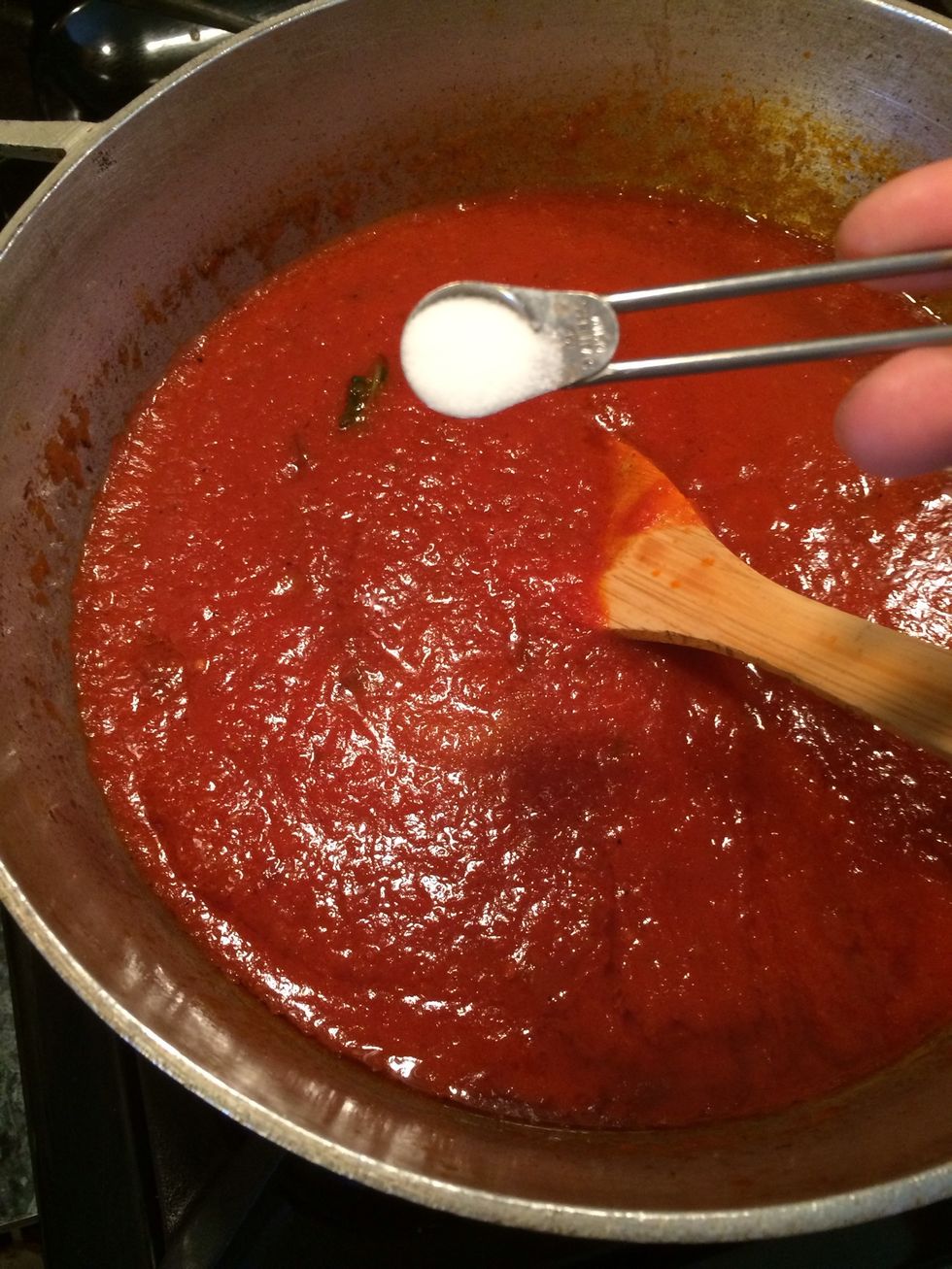 The sugar. This removes some of the acidity the sauce might have( totally optional)