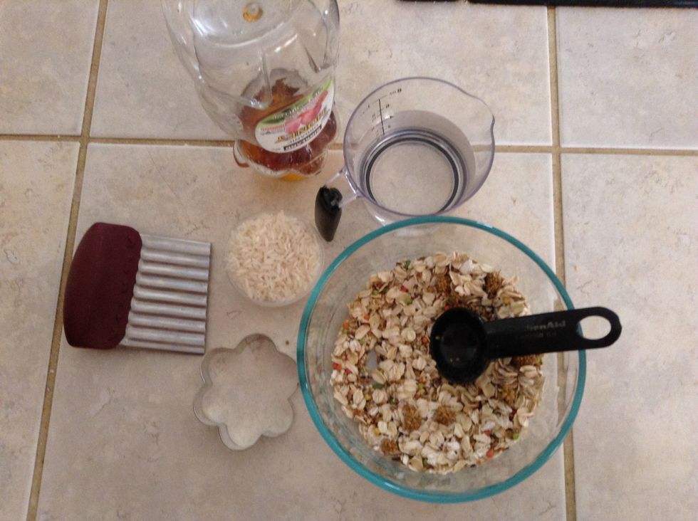 The supplies you will need are 4 tbs oats and 4 tablespoon parakeet food mixed, 2 tbs rice a cookie cutter, 1 tbs water, 2 tbs honey optional: fish oil 1 drop, foil and a blade