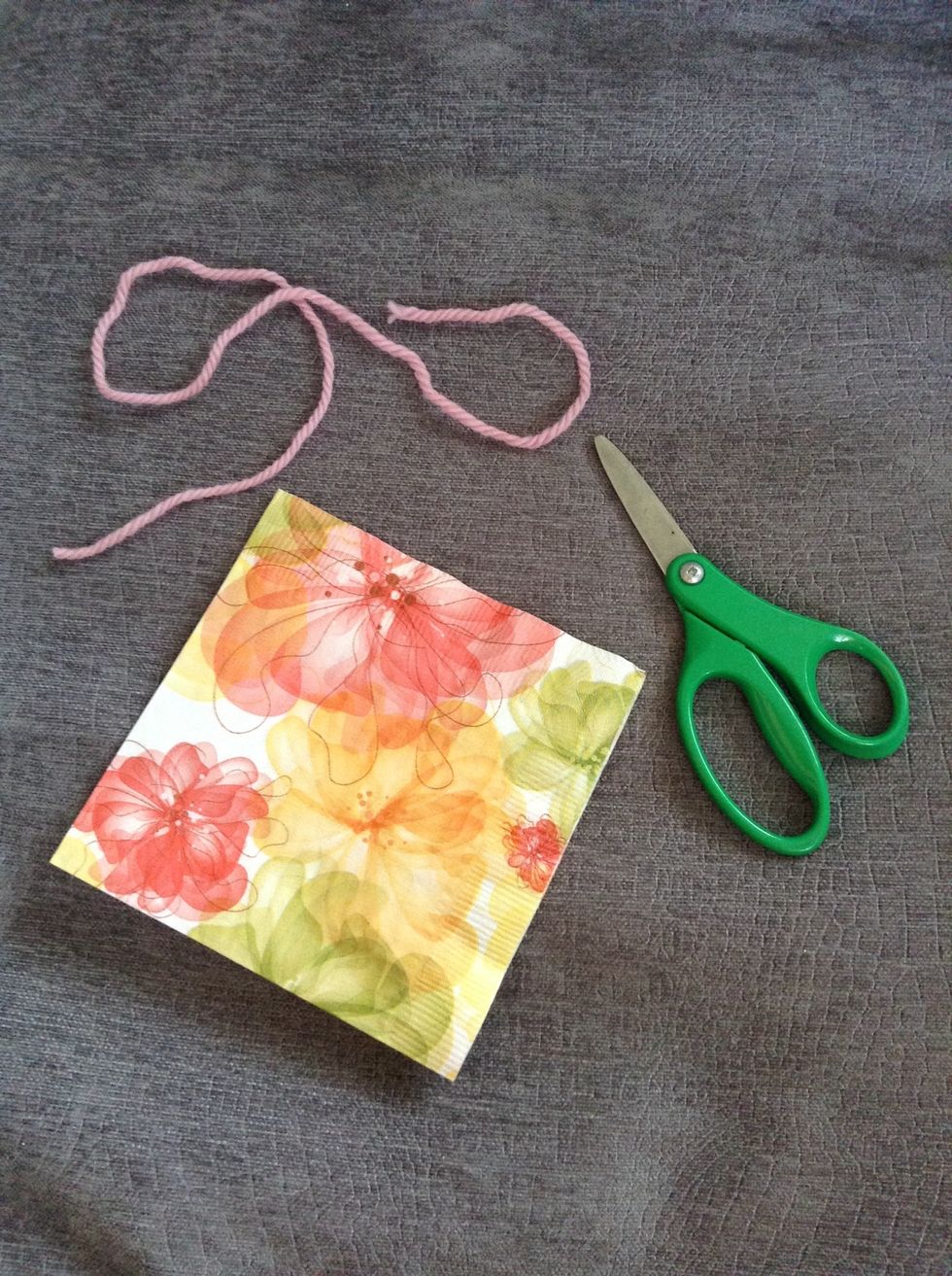 The supplies you will need are a napkin, scissors and some yarn