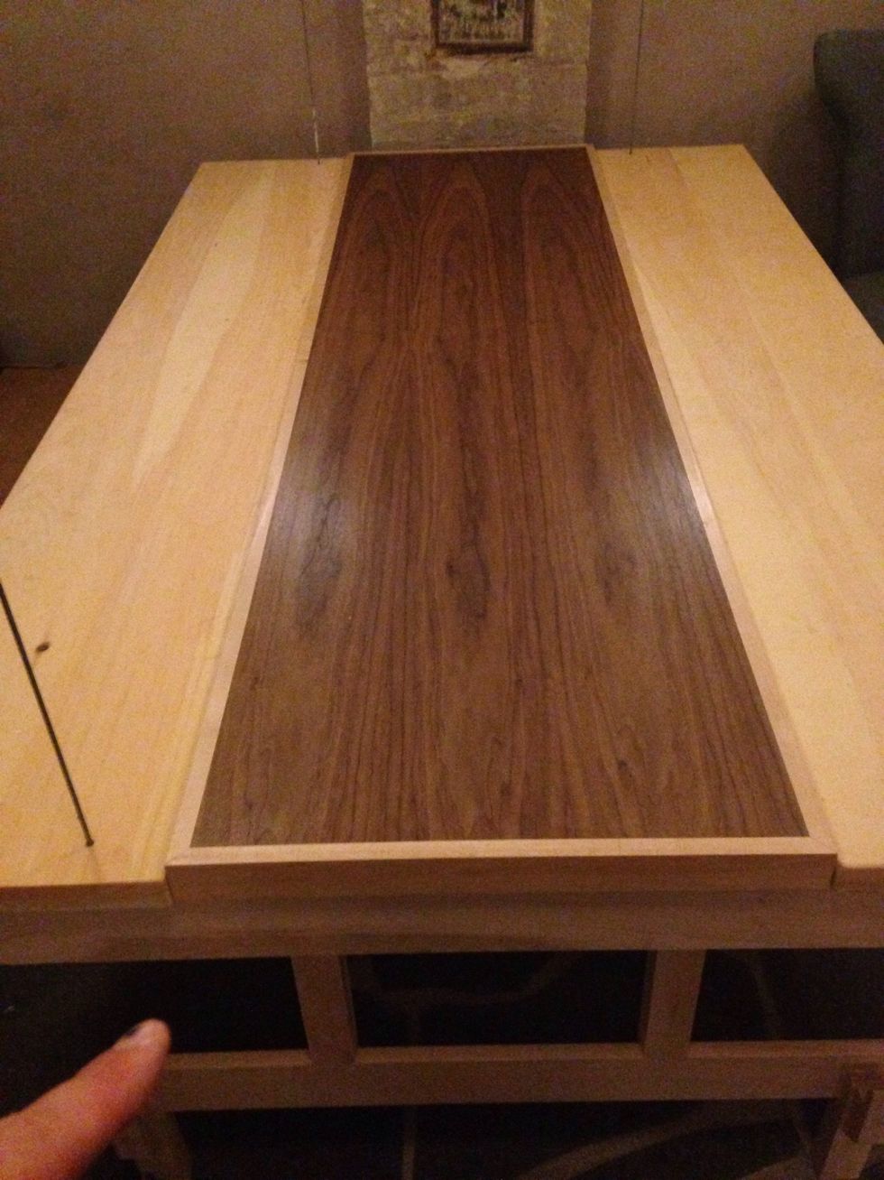 The table will raise when you push the stitch down