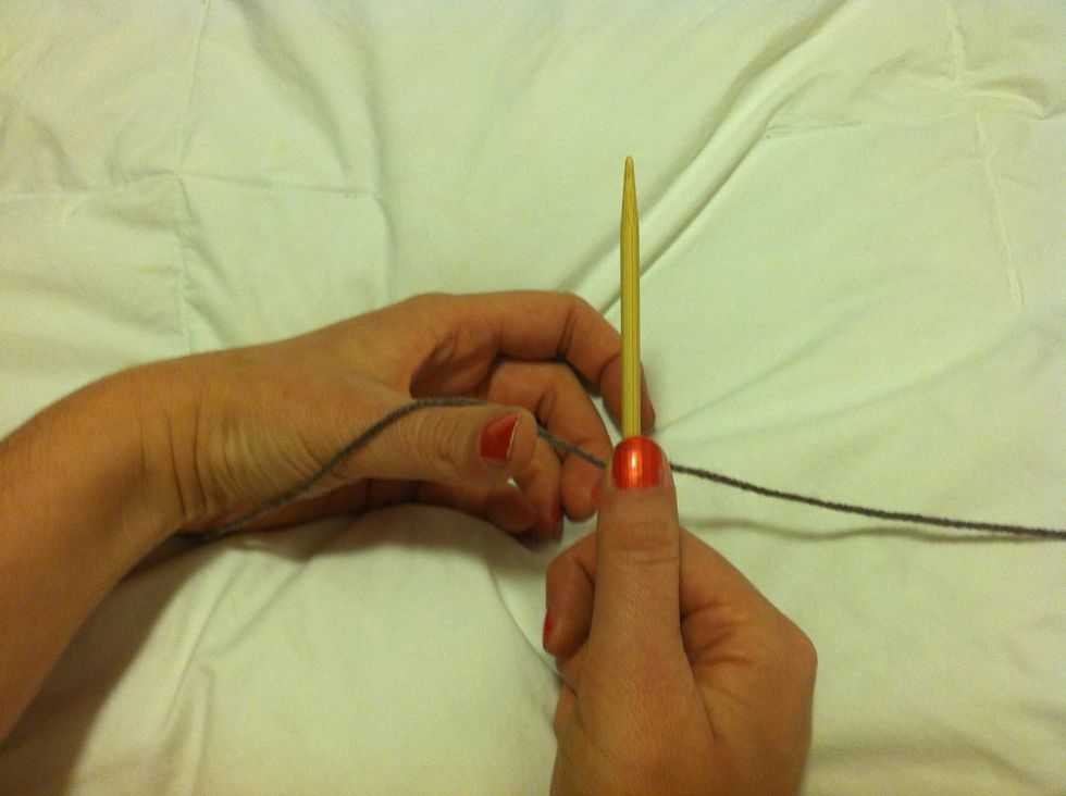 The tail should be to the left. Aprox 1 in/ 2 stitches. Pinch the yarn to the needle in your right hand.