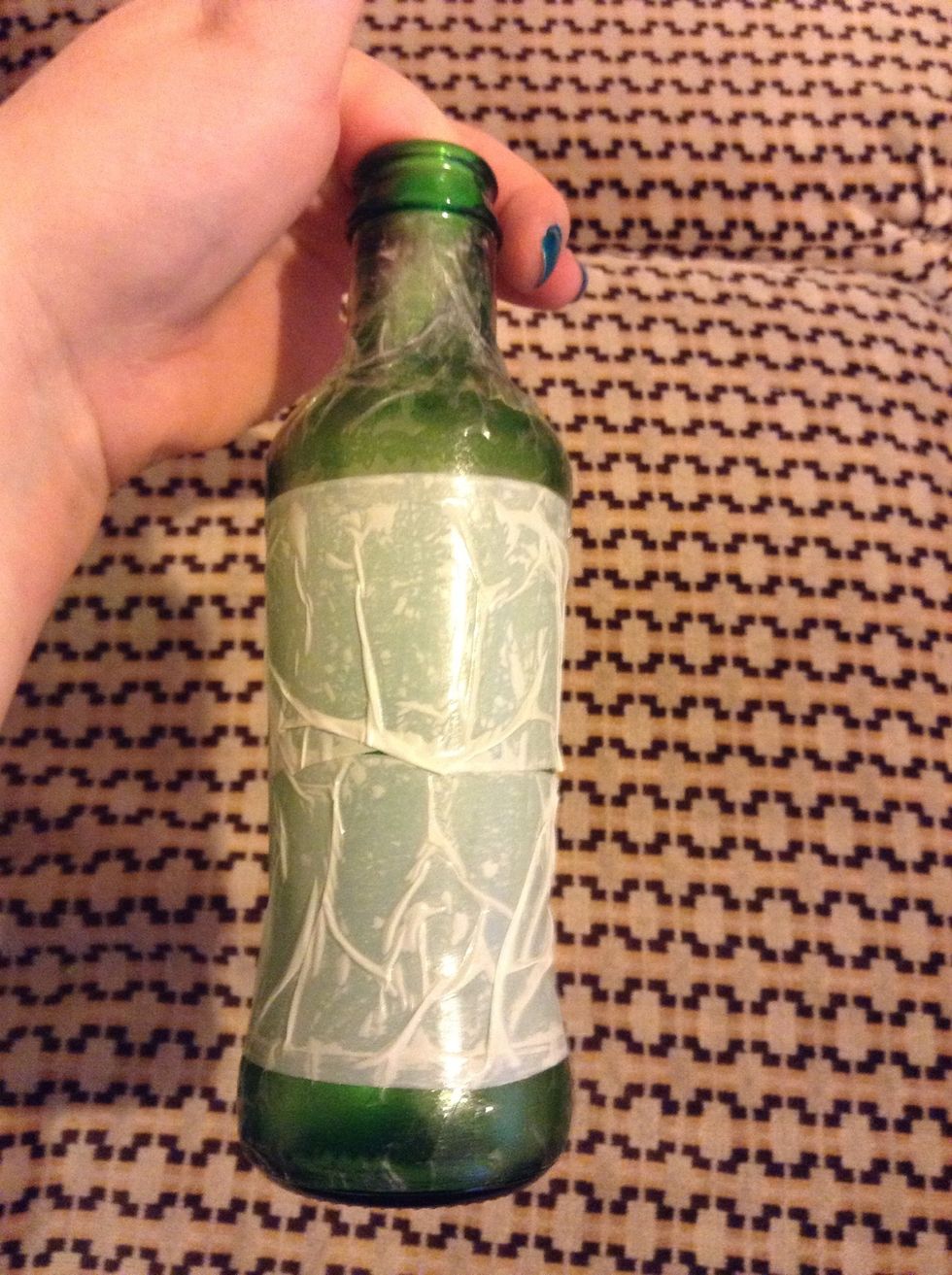 The tape won't lie perfectly against the bottle, but just smooth it out the best that you can, it won't be visible thru the yarn anyway.