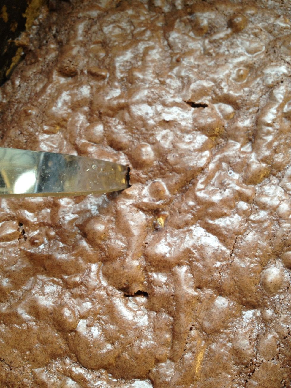 The test of it being ready is inserting a metal skewer or sharp knife in a few places in the tin and it being 'clean' when removed.