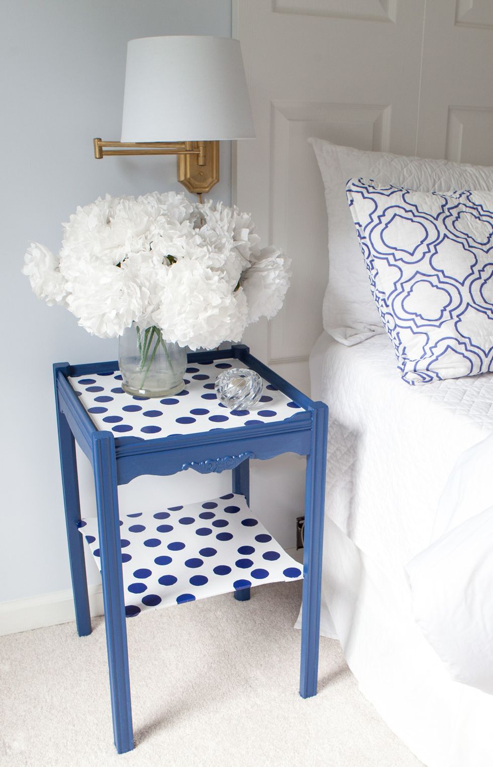 The thick glossy  paper is easy to clean. If placing a drink on the table, use a coaster to protect the finish.