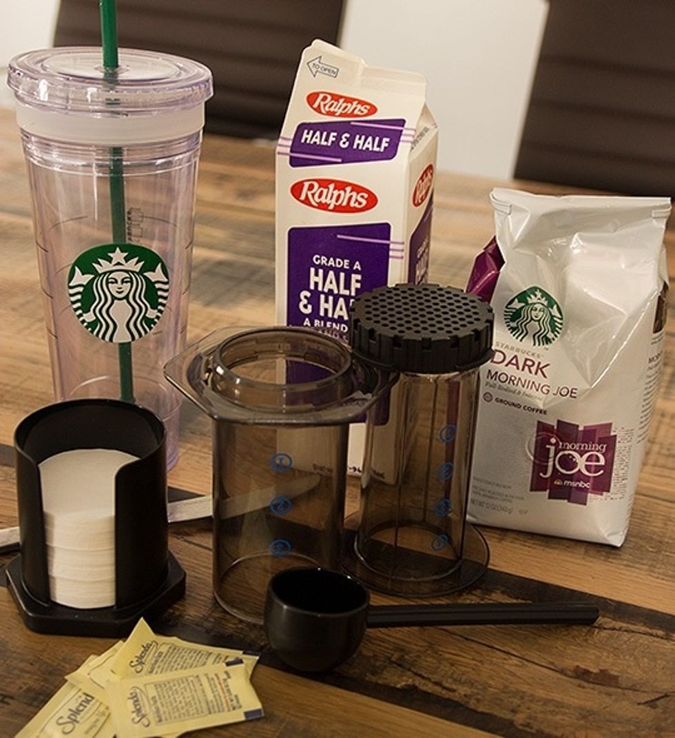 The tools: AeroPress with included filters and measuring spoon, Starbucks insulated iced coffee cup, some Starbucks ground coffee, half and half, Splenda and a knife for stirring.