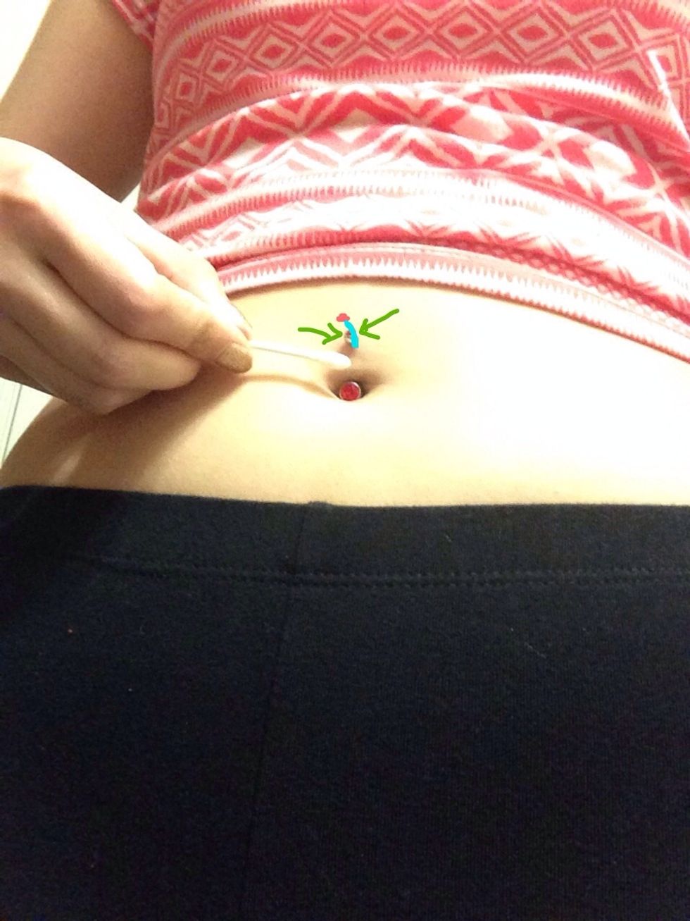 The top of the barbell should now be showing as you keep your finger pushing it up . The blue indicates the top of the barbell and the pink indicates the gem\u2728 the green arrows show to clean with q-tip