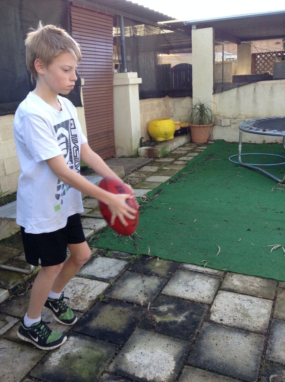 The top point of the ball should be inline with your chin.