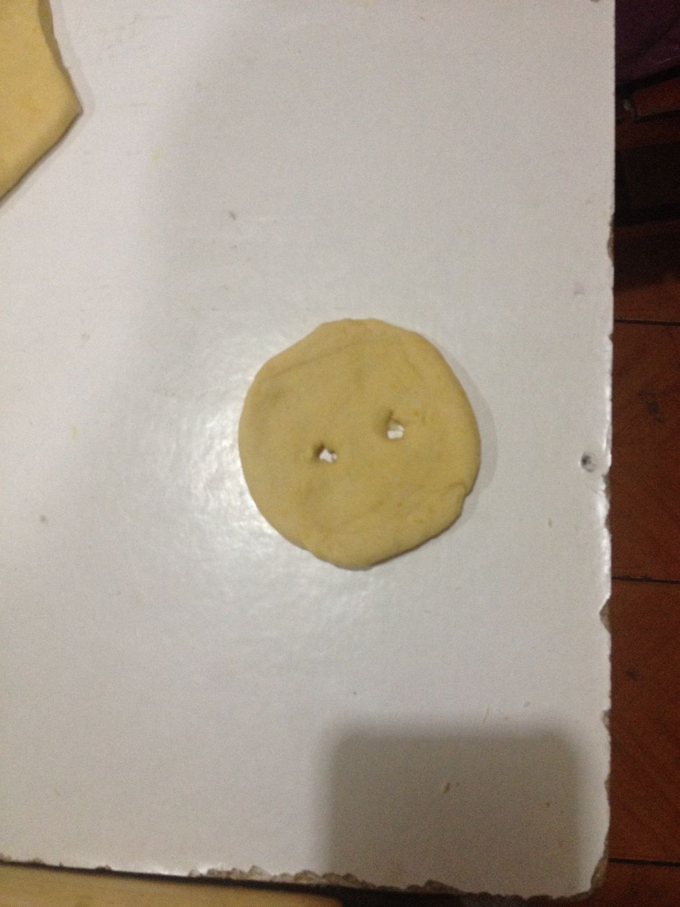 The traditional sopaipillas are round like this (either use a knife or a cookie cutter) but you can cut them into squares as well. Once you have your shapes, poke 2 holes per sopaipilla.