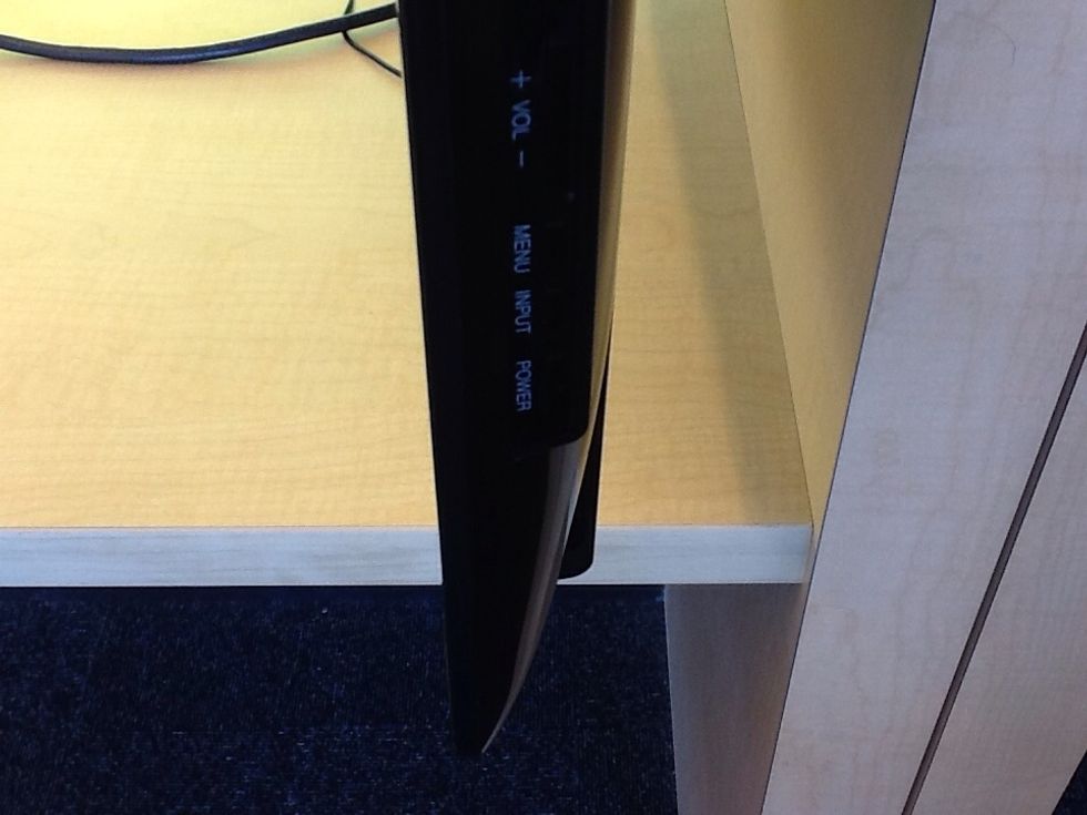 The TV should turn on automatically but sometimes it does not, press the power button on the right side of the TV if it does not turn on after a few seconds.