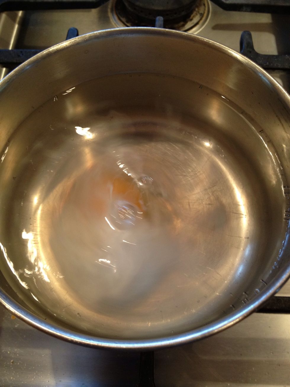 The vinegar and whirlpool will keep the egg mostly together. Don't worry if it swirls out of control a little.