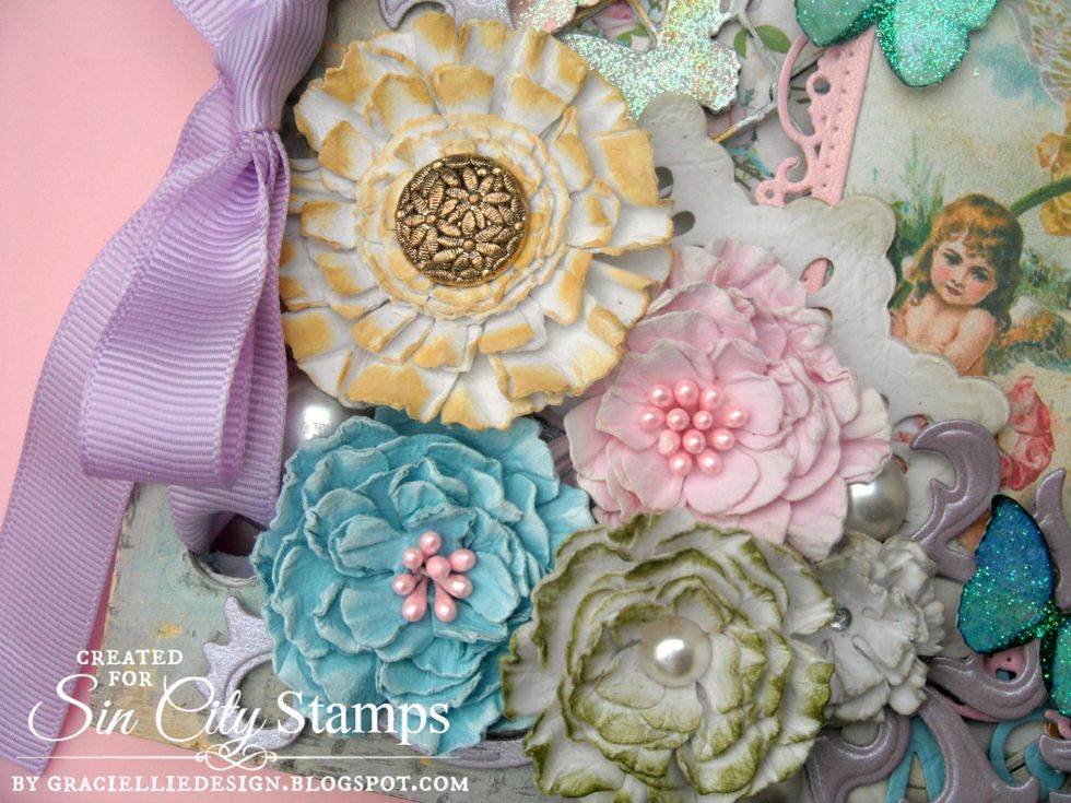 The vintage handmade flowers bouquet was added on the lower left corner, together with die cuts and pearls.