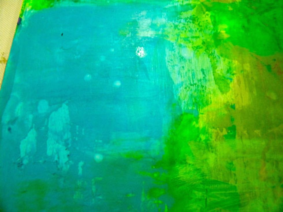 The water eats the paint away and leaves interesting marks. If the paint is dry, try using a heat gun on the water before scraping. Use this technique on all layers to reveal paint below.