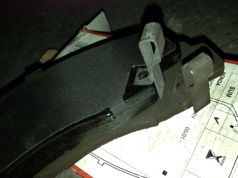 The wear warning makes it so it only fits one way. Reassemble (may have to push open the caliper even more) and repeat on other side.