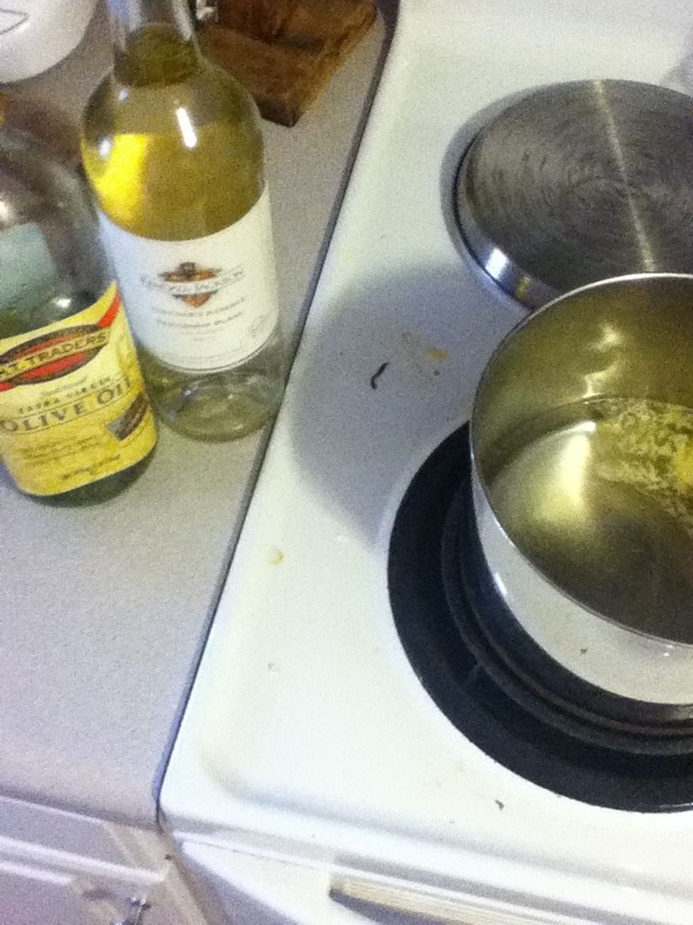 Then a light drizzle of olive oil plus a big old splash of wine. Neither has to be top quality, so feel free to use the cheap stuff. Sherry also works well.