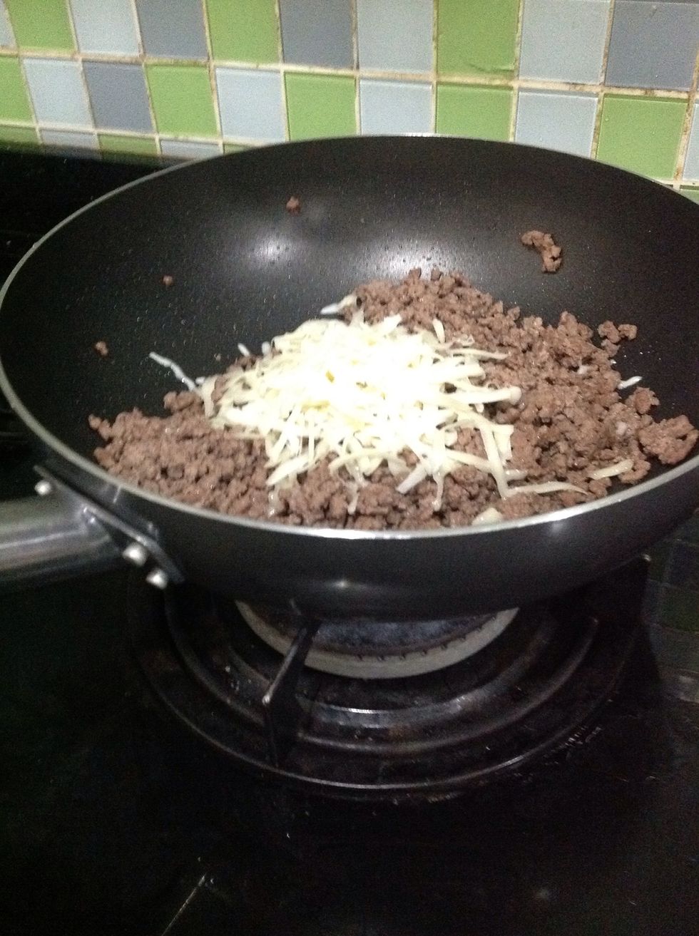 Then add 1/2 cup of Monterey Jack cheese to the beef and mix it up.