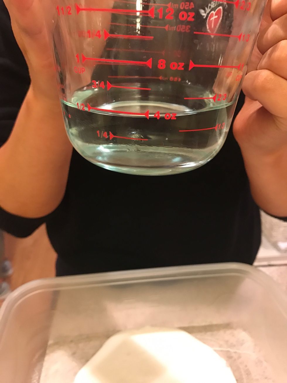 Then add 1/2 cup of water into the same bowl and mix. (Your empty glue bottle is also 1/2 of a cup).