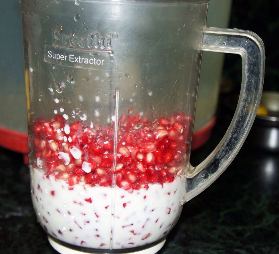 Then add 200 ml of pure milk to the pomegranate.