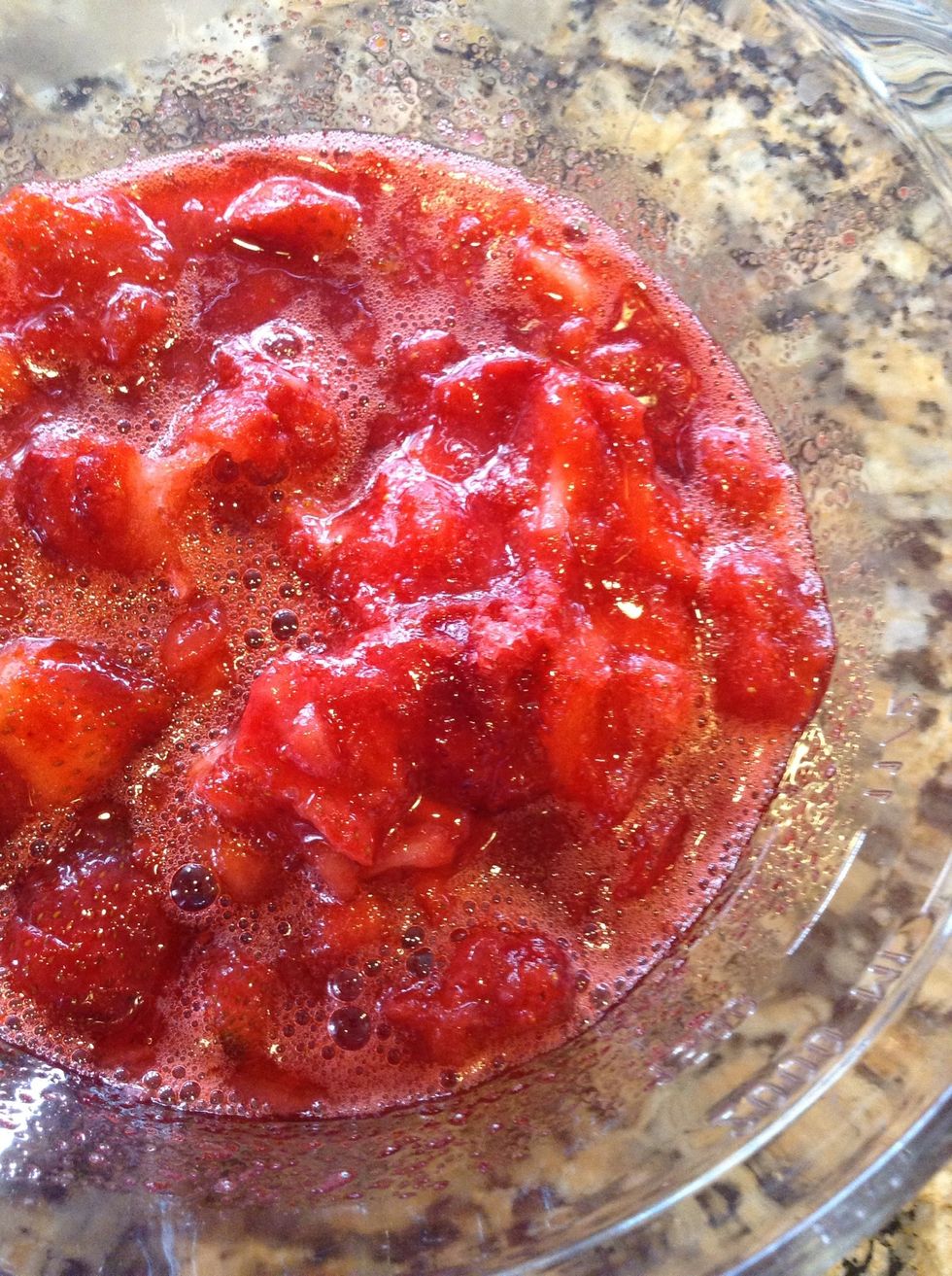 Then add a large container (16 oz) of frozen  sliced sugared strawberries. I like to add them as frozen, the hot water helps break it up and also helps cool it down quicker so that you can spread.