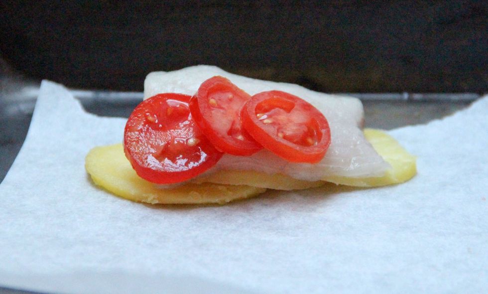 Then add a layer of fish and one of tomatoes