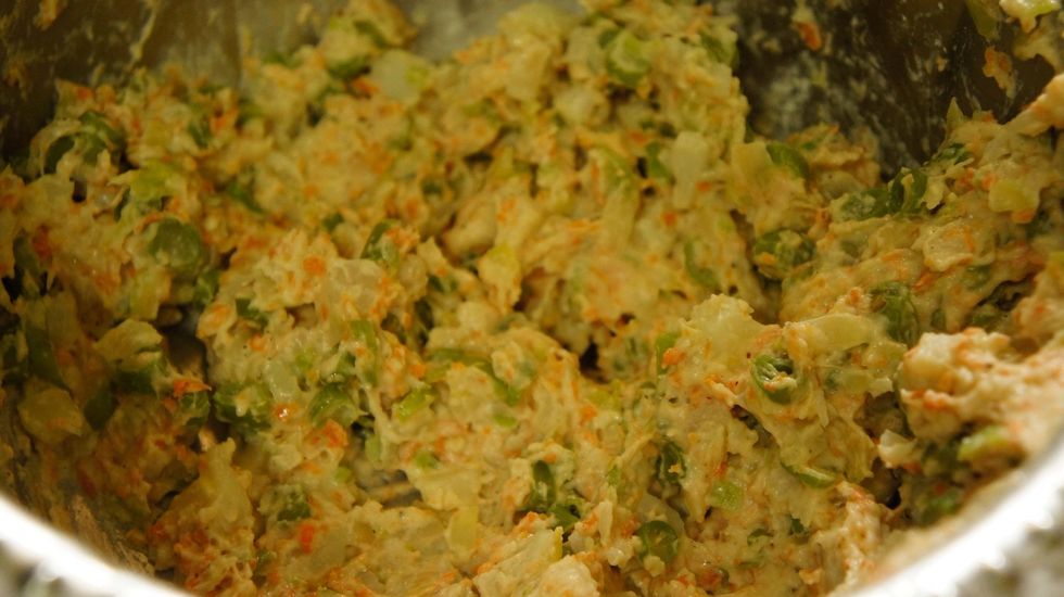 Then add a pinch of salt, 1.5 cup of refined flour, chopped green chilli and corn flour to the mixture and make it as a batter