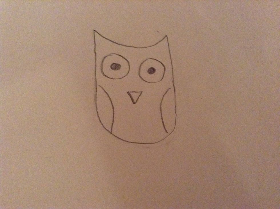 Then add an upside down triangle for the beak and add 2 semi circles at the sides making the wings