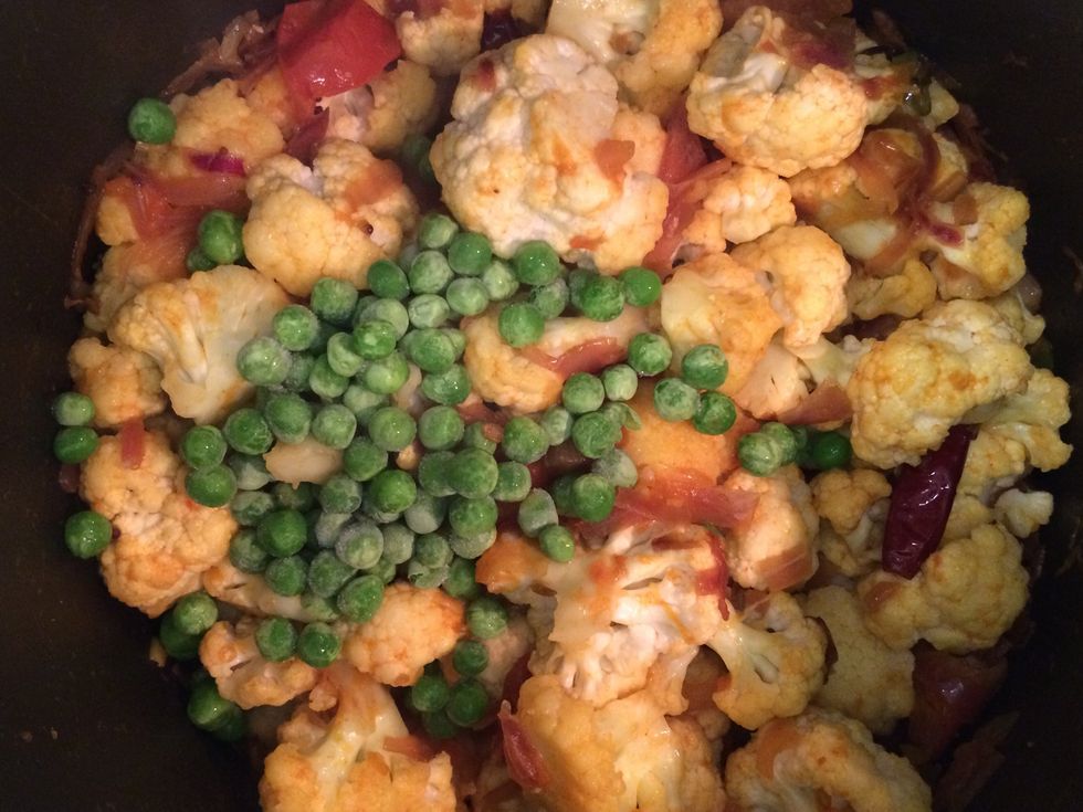 Then add cauliflower and green peas. Mix thoroughly.