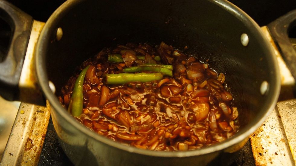 Then add chopped garlic, ginger, green chilli, red chilli sauce, soya sauce, vinegar...