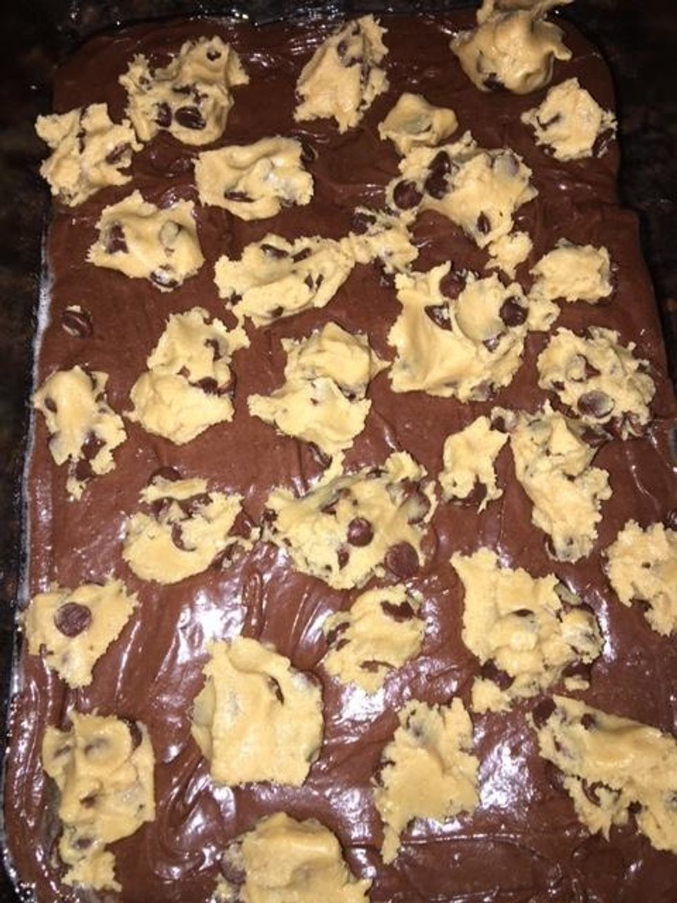Then, add drops of cookie dough by rounding tablespoonfuls evenly onto brownie batter. Then bake it in the oven