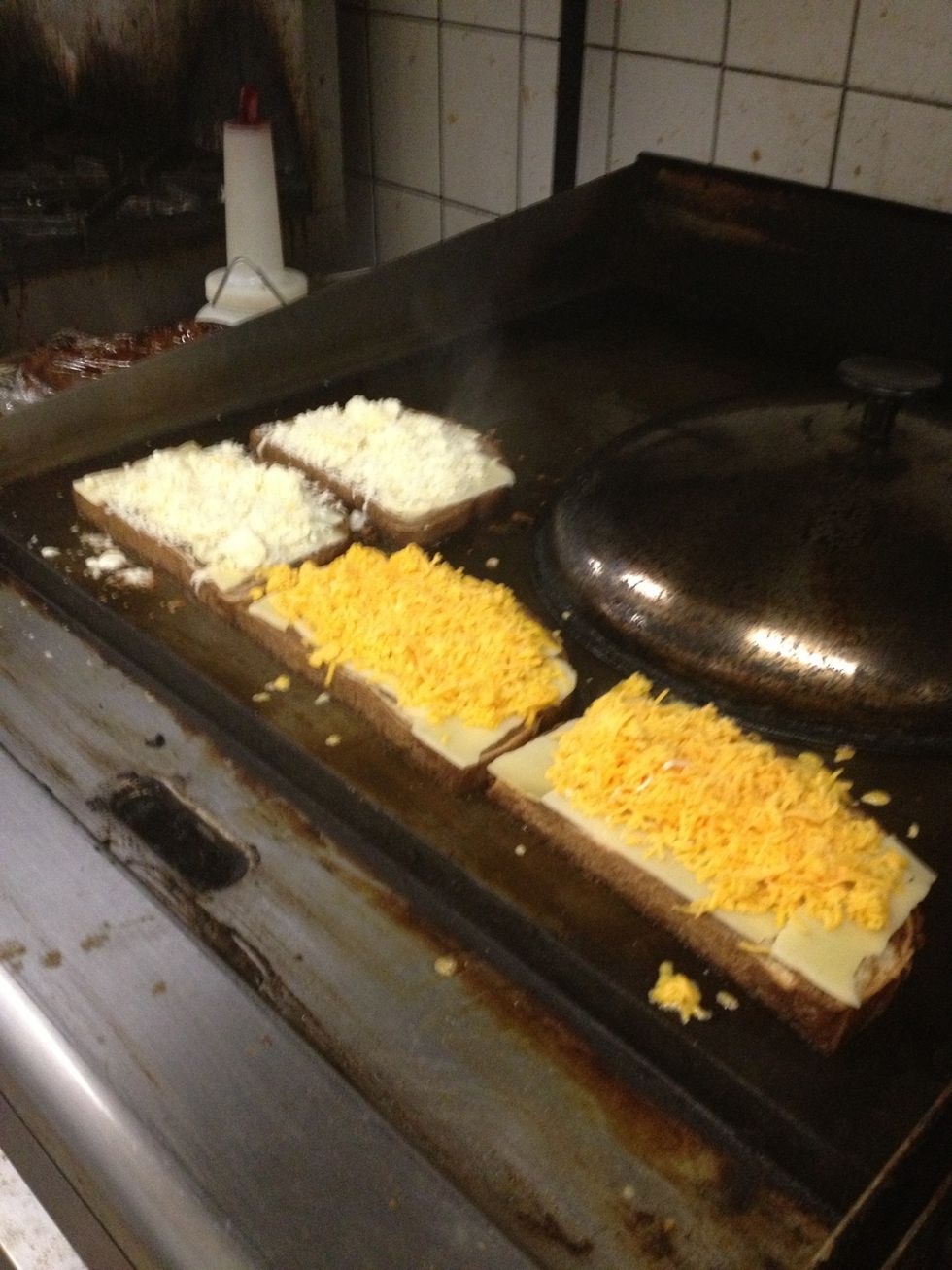 Then add even more cheese. That's mozzarella Swiss and cheddar cheese on the bun and in the burger