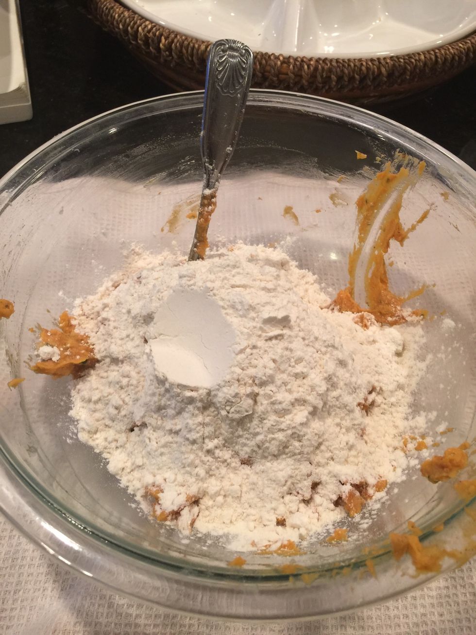 Then add flour to sweet potato pur\u00e9e. 1 cup of flour at a time mixing each time you add. I added 2 1/2cups