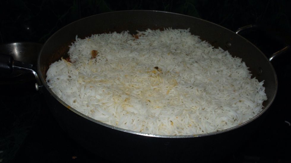 Then add half boiled basmati rice to it...
