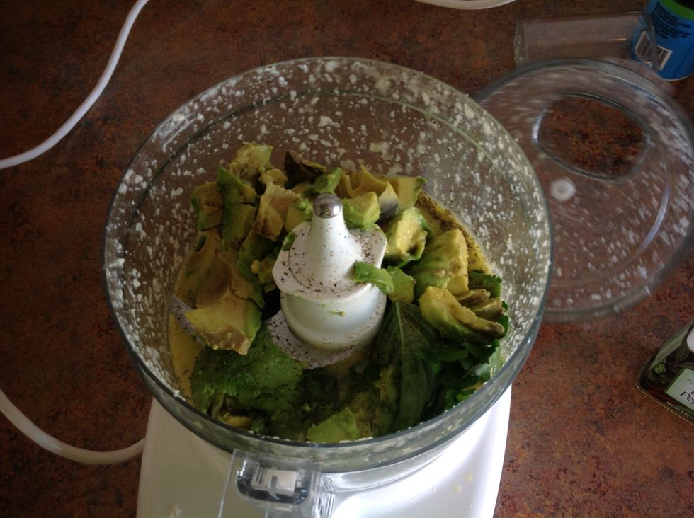 Then add herbs and avocado, salt, and pepper to the food processor. Blend till smooth.